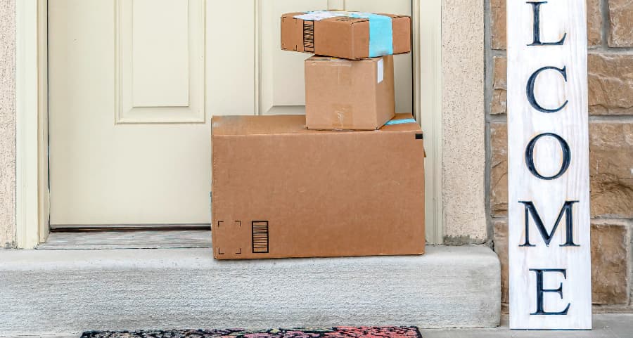 Deliveries on the front porch of a house with a welcome sign in Syracuse